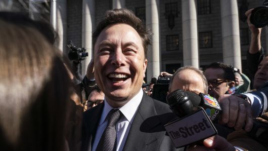 Elon Musk, chief executive officer of Tesla Inc., smiles while speaking to members of the media outside federal court in New York, U.S., on Thursday, April 4, 2019.