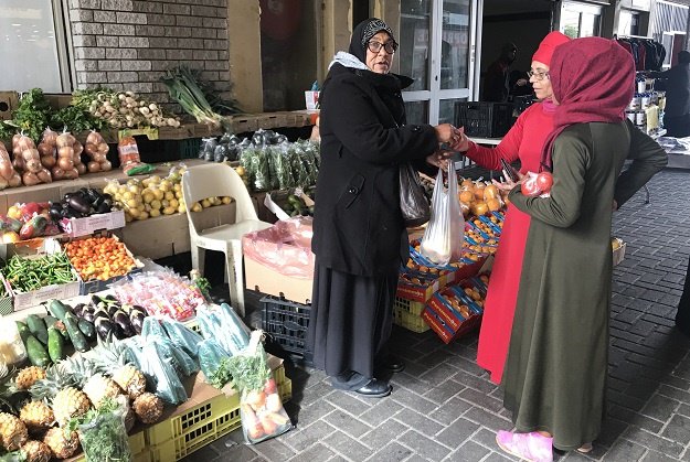 Sharifa Cloete, a vegetable vendor helps customers