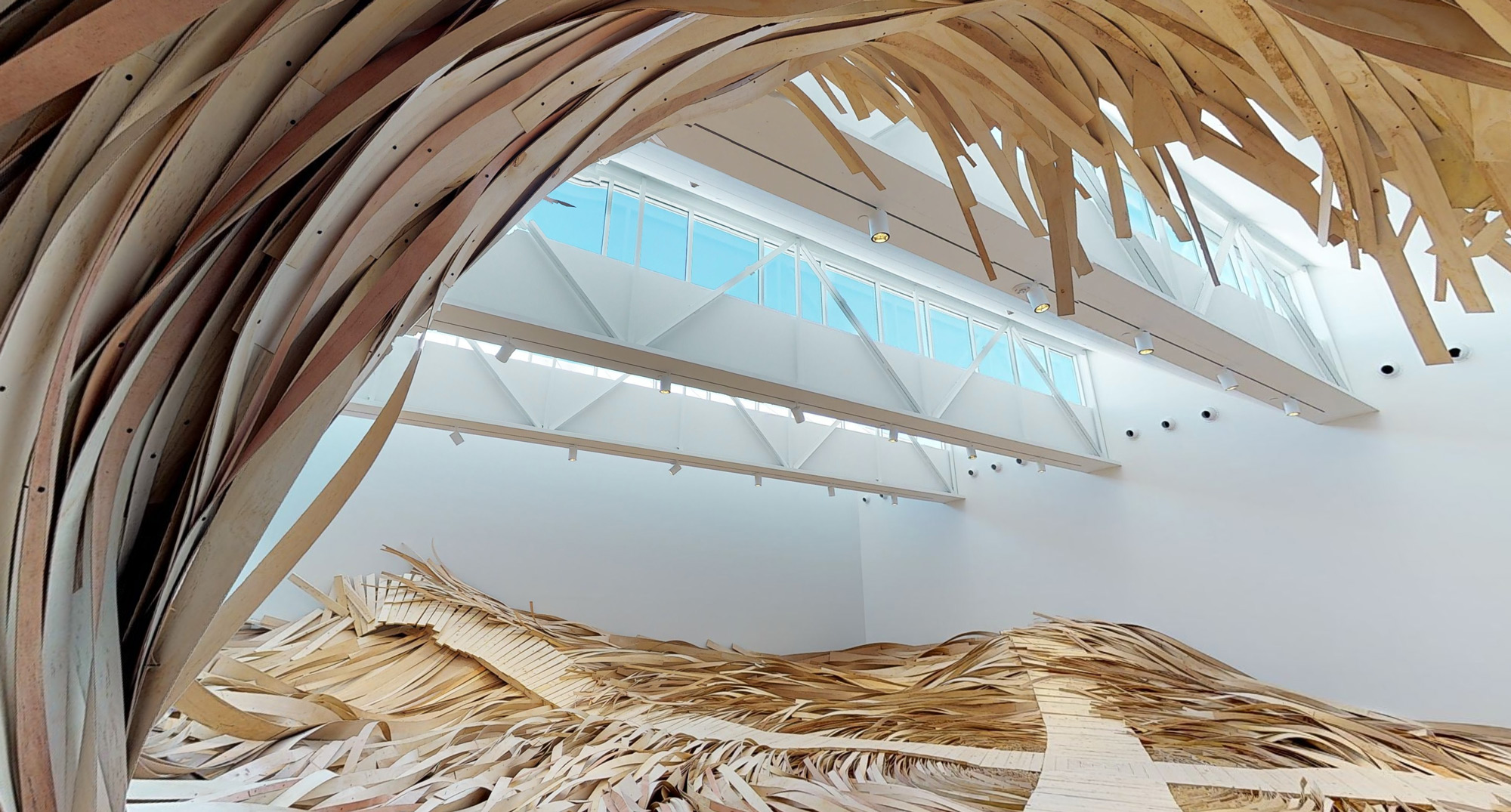 A Massive Wooden Wave Surges From a Gallery Floor in an Installation by Wade Kavanaugh and Stephen B. Nguyen